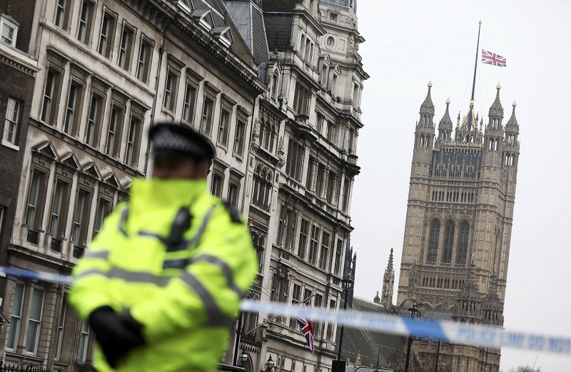 A police officer stands on duty as the union flag flies over Parliament at half-mast the morning after an attack by a man driving a car and wielding a knife left five people dead and dozens injured, in London March 23, 2017. u00e2u20acu201d Reuters pic