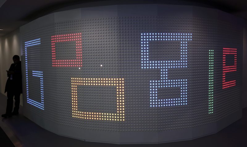 A man checks his mobile phone next to an illuminated panel at Google stand during the Mobile World Congress in Barcelona March 1, 2017. u00e2u20acu201d Reuters pic