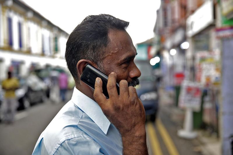 A man uses a 2G phone at Little India, Singapore, December 8, 2016. u00e2u20acu201d TODAY pic