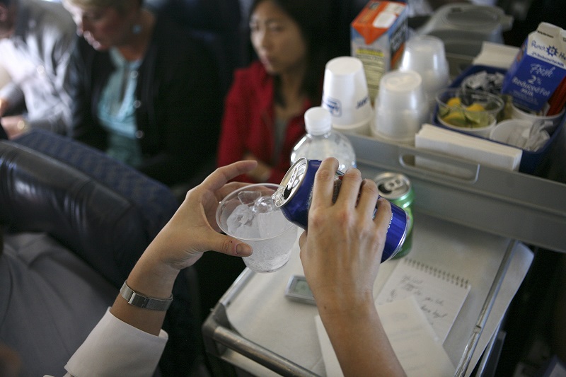 A soft drink is poured into a plastic cup of ice on a commercial airline flight in the US, July 15, 2008. u00e2u20acu201d Picture byb Ruth Fremson/The New York Times