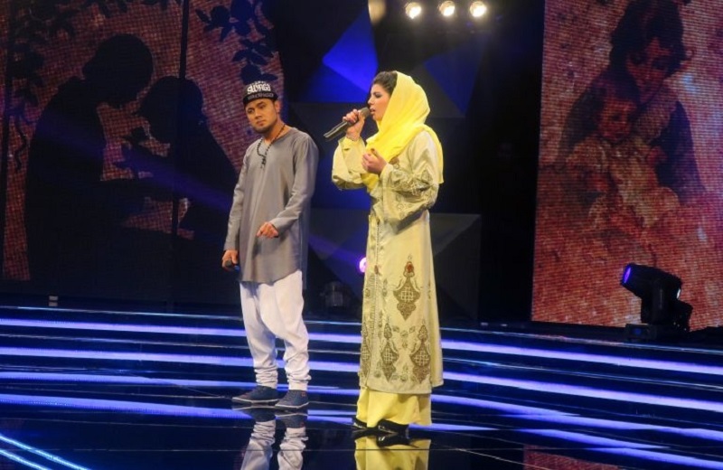 In this photograph taken on March 9, 2017, young Afghan singer Zulala Hashemi (right) stands alongside competitor Sayed Jamal Mubarez as they perform during the television music competition u00e2u20acu02dcAfghan Staru00e2u20acu2122 in Kabul. u00e2u20acu201d AFP pic