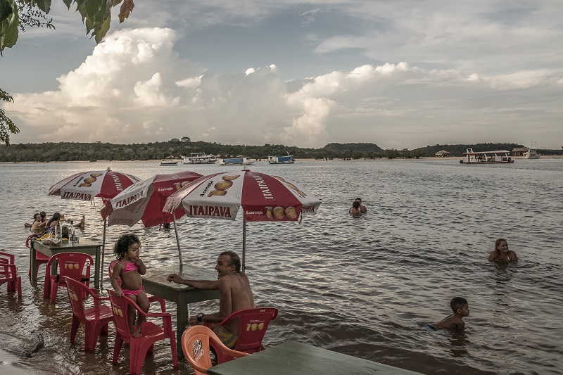People relax at tables in the shallow shoreline waters of the beach along the Tapajos River in Alter Do Chao, Brazil, February 4, 2017. — Picture by Bryan Denton/The New York Times 