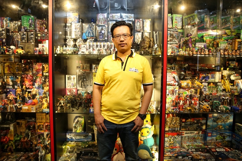 Oska Chin poses with some of the toys he sells at his shop in Sungei Wang Plaza.