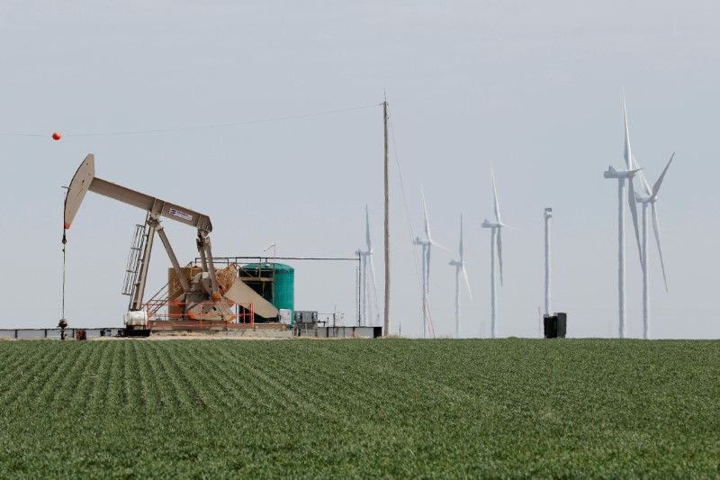 An oil derrick and wind turbines stand above the plains north of Amarillo, Texas March 14, 2017. u00e2u20acu201d Reuters pic 