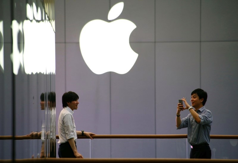 A man uses his phone to take pictures outside an Apple store in Beijing, China July 28, 2016. u00e2u20acu201d Reuters pic
