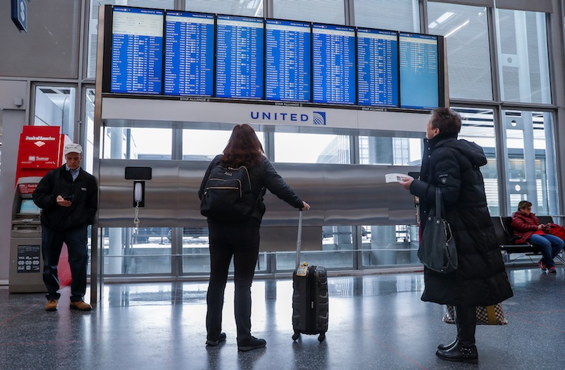 Travelers check the departure board in the United Airlines terminal during the snowstorm at O'Hare International Airport in Chicago, Illinois, March 13, 2017. u00e2u20acu201d Reuters pic