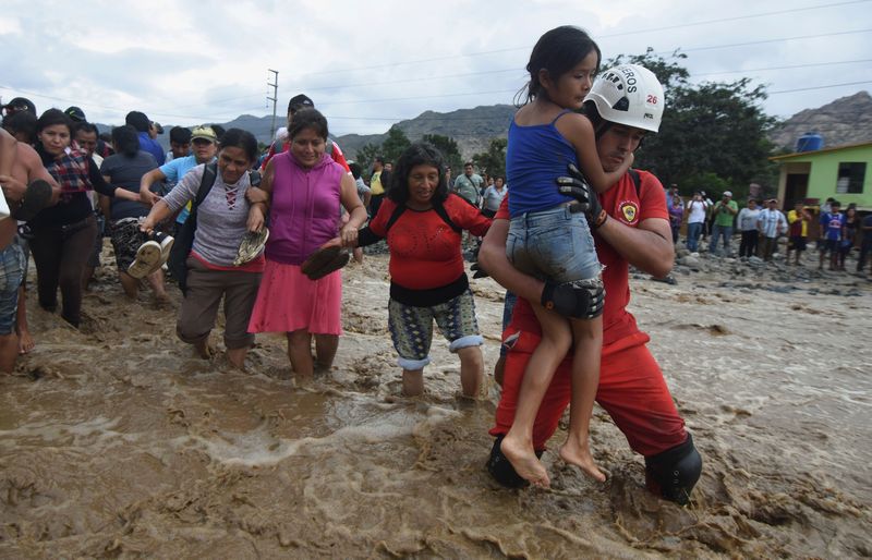 Residents cross a flooded street after a massive landslide and flood in Trujillo, northern Peru March 17, 2017. u00e2u20acu201d Reuters pic