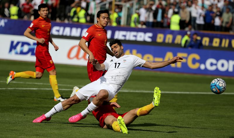 Iranu00e2u20acu2122s Mehdi Taremi (left) plays against Chinau00e2u20acu2122s Zhang Linpeng during the 2018 World Cup qualifying match between Iran and China at the Azadi Stadium in Tehran on March 28, 2017. u00e2u20acu201d AFP pic