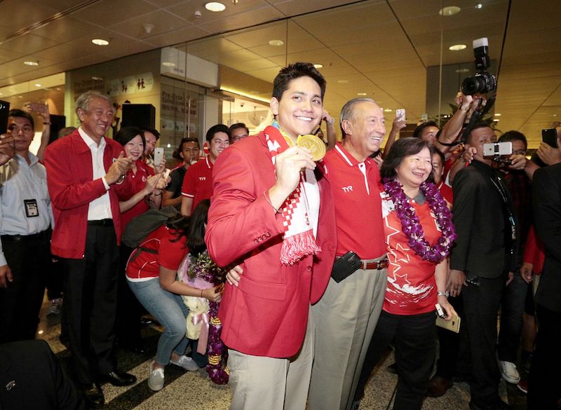 Joseph Schooling with his parents at Changi Airport last year after winning Olympic gold in the 100m butterfly. u00e2u20acu201d TODAY pic