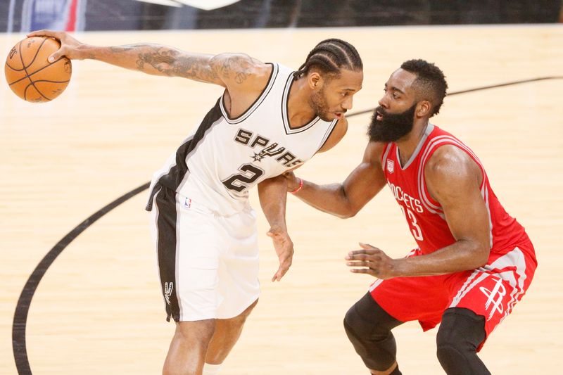 San Antonio Spurs' Kawhi Leonard (left) being blocked by Houston Rockets' James Harden in their NBA match in San Antonio March 6, 2017. u00e2u20acu201d USA TODAY Sports/Reuters pic