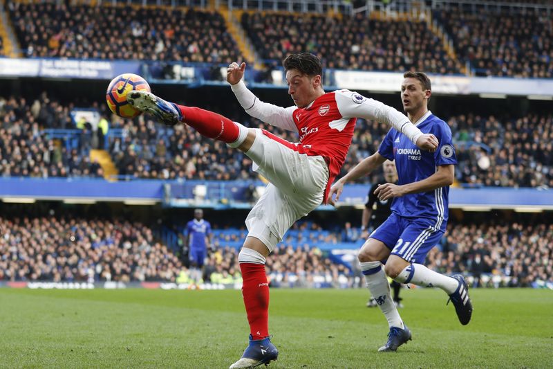 File picture shows Arsenalu00e2u20acu2122s German midfielder Mesut Ozil volleying the ball during the English Premier League football match between Chelsea and Arsenal at Stamford Bridge in London on February 4, 2017. u00e2u20acu201d AFP pic
