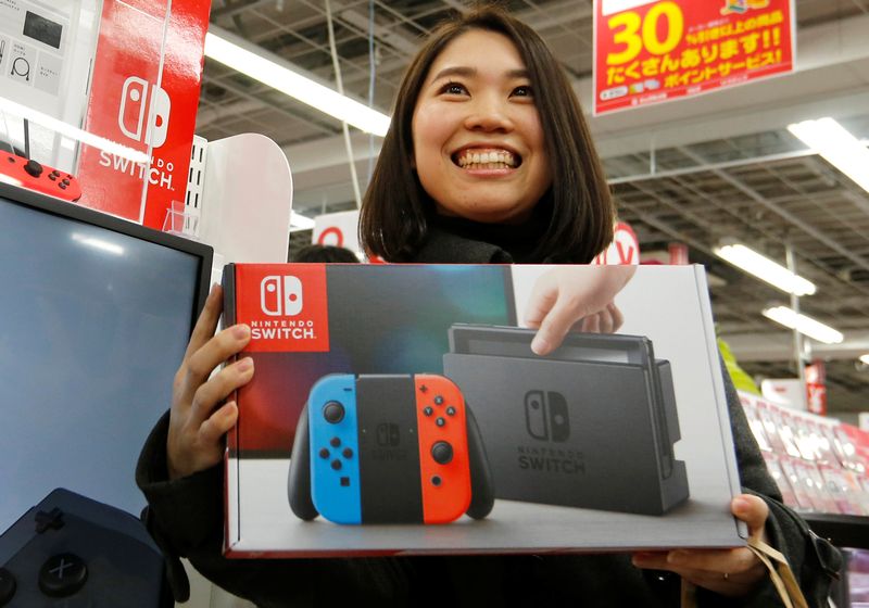 Nao Imoto smiles as she poses with her Nintendo Switch game console after buying it at an electronics store in Tokyo March 3, 2017. u00e2u20acu201d Reuters pic 
