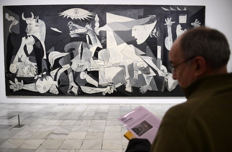 A man looks at Spanish artist Pablo Picassou00e2u20acu2122s painting, u00e2u20acu02dcGuernicau00e2u20acu2122 at Reina Sofia museum in Madrid March 24, 2017. u00e2u20acu201d AFP pic