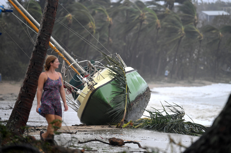 A local resident walks past a yacht that was washed ashore after Cyclone Debbie hit the northern Queensland town of Airlie Beach March 29, 2017. u00e2u20acu201d Picture by Dan Peled/AAP via Reuters