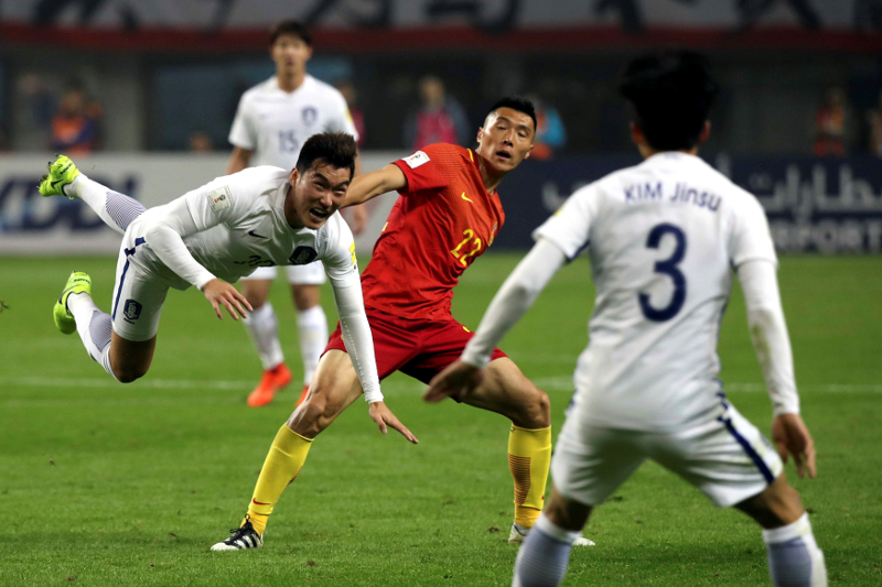 Chinau00e2u20acu2122s Yu Dabao and South Koreau00e2u20acu2122s Jang Hyunsoo in action during their World Cup qualifying match in Changsha March 23, 2017. u00e2u20acu201d Reuters pic
