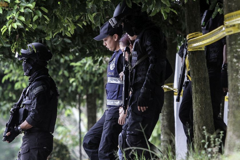 Indonesian Siti Aisyah (centre) is escorted by police out of the Sepang magistrateu00e2u20acu2122s court on March 1, 2017. u00e2u20acu201d Picture by Yusof Mat Isa