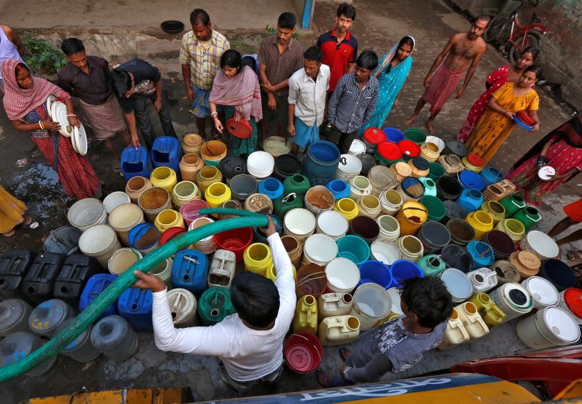 Residents wait as they get their containers filled with drinking water from a municipal tanker at a slum in Kolkata March 22, 2017. u00e2u20acu2022 Reuters pic