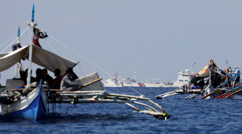 China Coast Guard vessels patrol past Philippine fishing boats at the disputed Scarborough Shoal, April 10, 2017.u00c2u00a0 u00e2u20acu201d Reuters pic