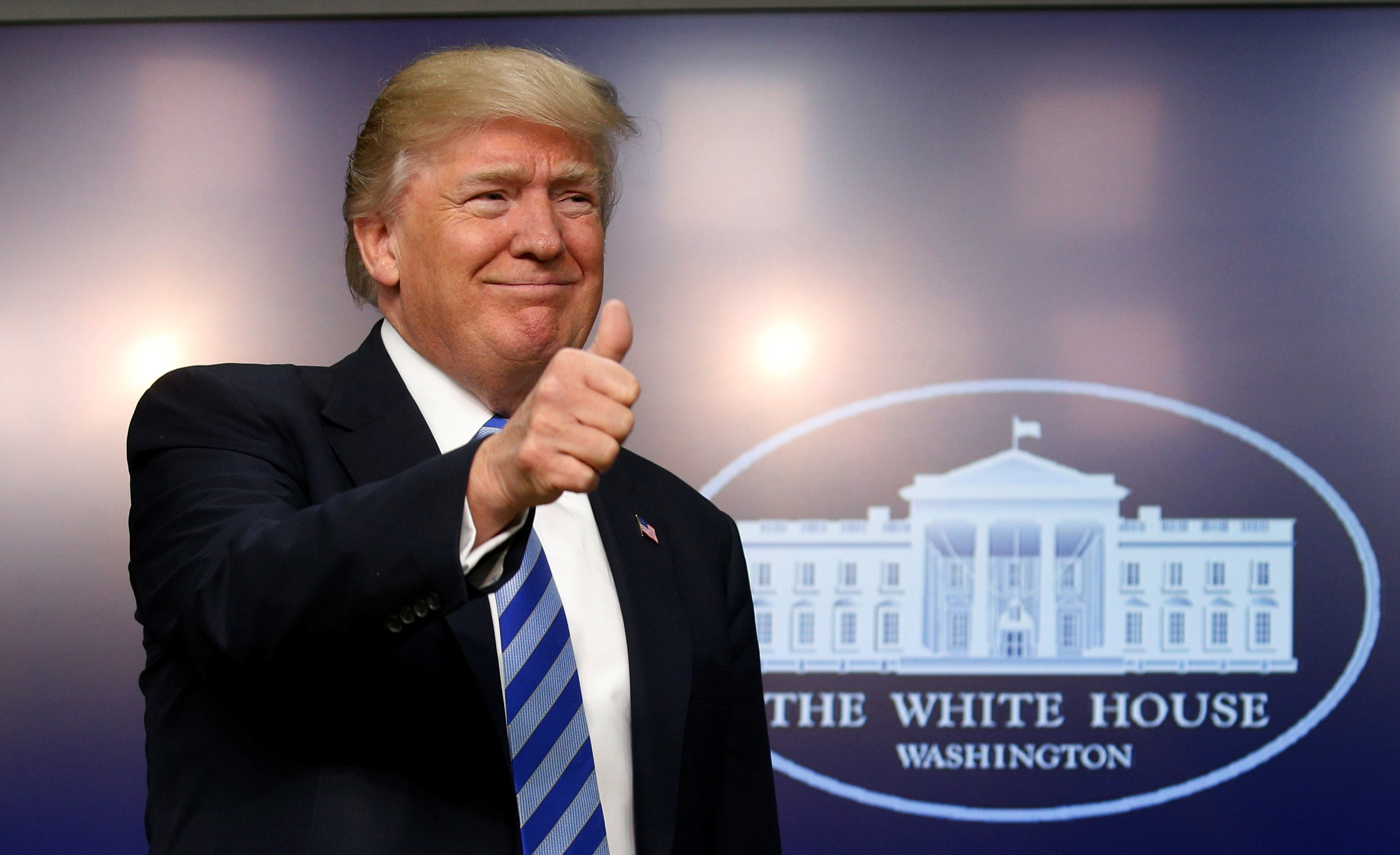 U.S. President Donald Trump gives a thumbs up as he hosts a CEO town hall on the American business climate at the Eisenhower Executive Office Building in Washington, U.S., April 4, 2017. REUTERS/Kevin Lamarquen