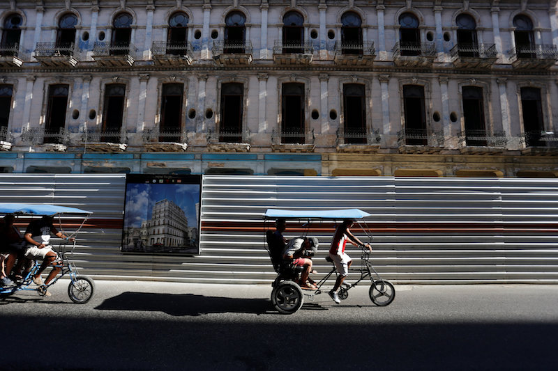 Pedicabs drive past a historic building undergoing restoration work to become a hotel in Havana March 28, 2017. u00e2u20acu201d Reuters pic