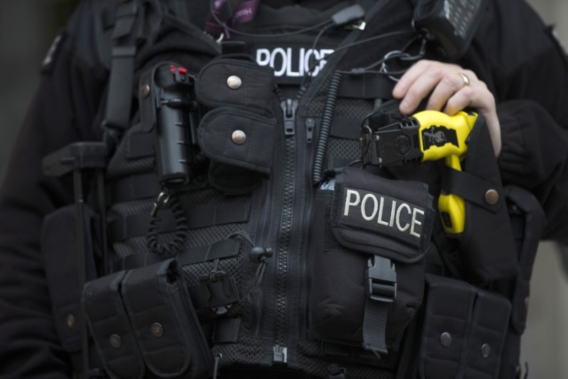 An armed police officer rests his hand on a Taser outside the Ministry of Defence in London November 18, 2015. u00e2u20acu201d Reuters pic