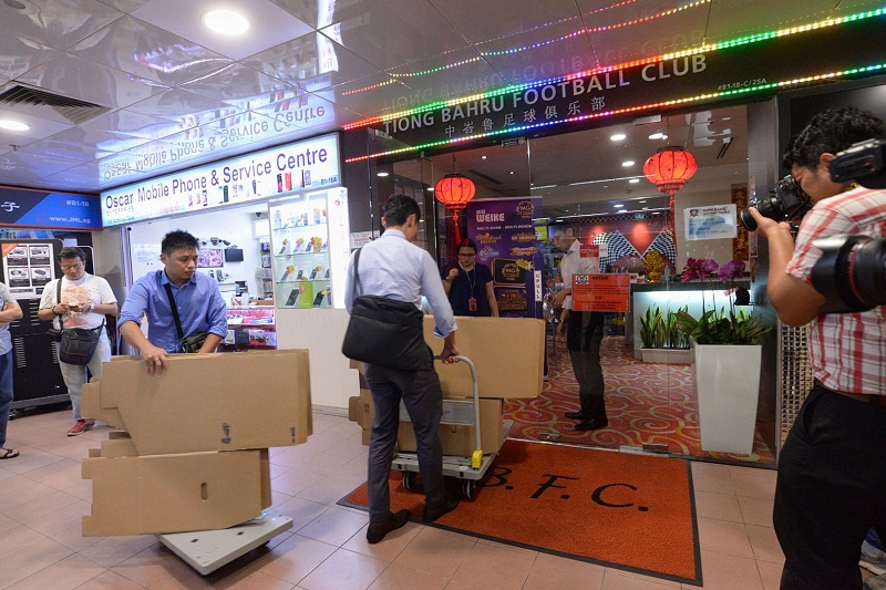 Investigators arriving with carton boxes and push trolleys at Tiong Baru Football Club clubhouse at Peopleu00e2u20acu2122s Park Centre. u00e2u20acu201d TODAY pic