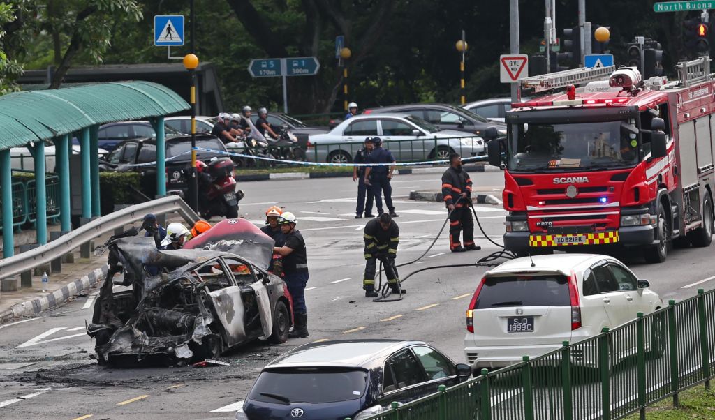 The charred taxi along Commonwealth Avenue on Sunday afternoon (April 30). u00e2u20acu201d TODAY picnn