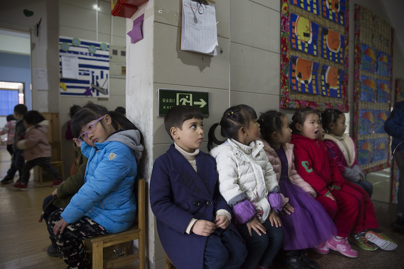 Alo-baidi Yousif (centre), an Iraqi child born in China, sits with other children in a kindergarten in Yiwu, Zhejiang Province 11 January 2017. u00e2u20acu201d Thomson Reuters pic