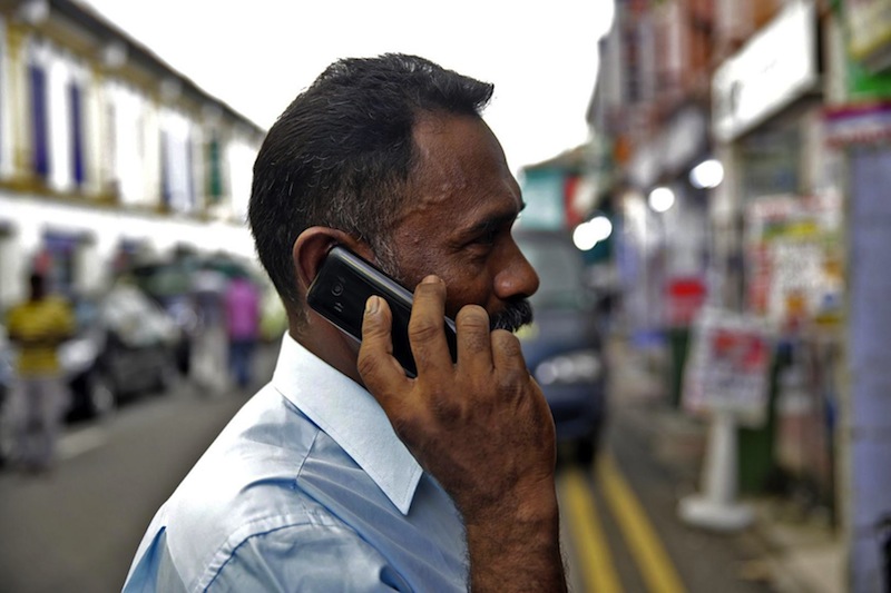Man using a 2G phone at Little India. u00e2u20acu201du00c2u00a0TODAY file pic