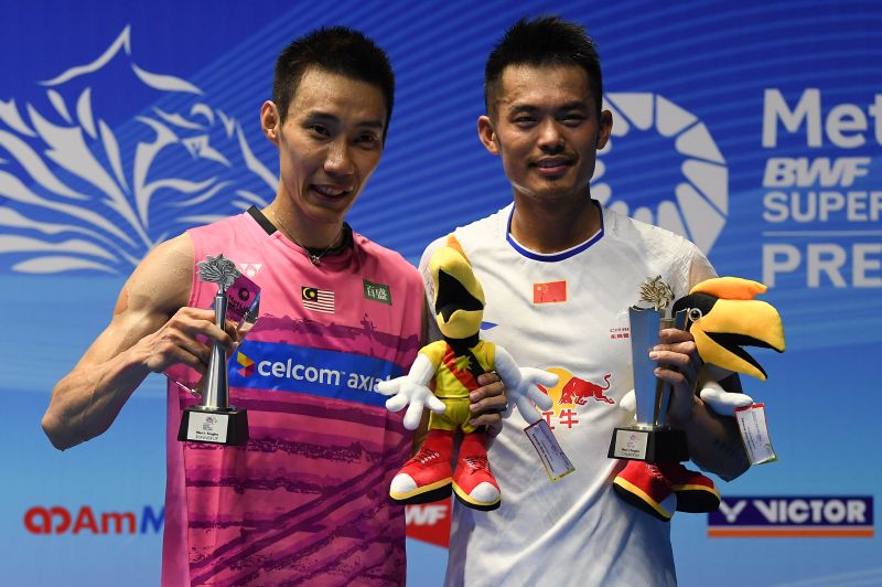 Winner Lin Dan of China (right) poses with runner-up Lee Chong Wei of Malaysia (left) on the podium during the awards ceremony following the menu00e2u20acu2122s singles final match at the Malaysia Open Badminton Superseries in Kuching on April 9, 2017. u00e2u20acu201d AFP pic