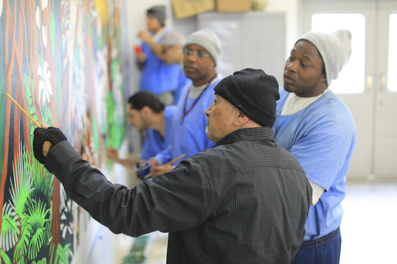 Instructor Guillermo Aranda (centre) and inmates work on a mural project at Salinas Valley State Prison in Soledad, California, January 20, 2017. — Picture by Jim Wilson/The New York Times