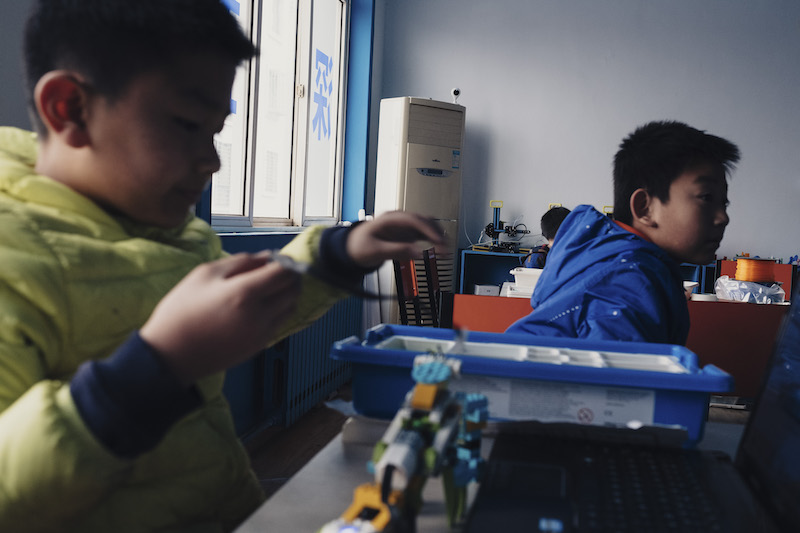Children assemble robots under a live-streaming camera at the Deep Blue Children Robot Centre in Jimo, Shandong Province, March 26, 2017. u00e2u20acu201d Picture by Yuyang Liu/The New York Times