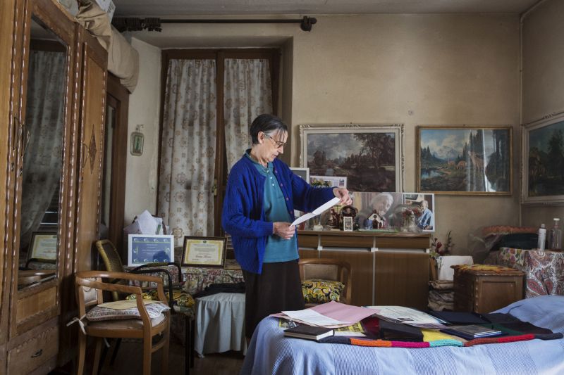 Rosemarie Santoni, the wife of one of Emma Morano's nephews who assisted her, gathers some of Morano's personal belongings in her small two-room church-owned apartment. ― Picture by Gianni Cipriano/The New York Times