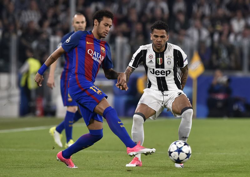 Barcelonau00e2u20acu2122s Neymar in action with Juventus' Dani Alves during their Uefa Champions League quarterfinal first leg match in Juventus Stadium, Turin, April 11, 2017. u00e2u20acu201d Reuters pic