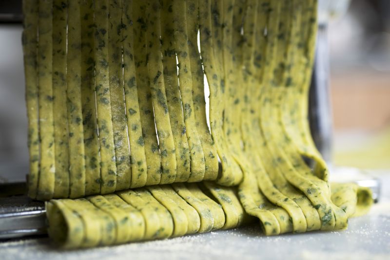 Herbed pasta dough is cut into noodles with a pasta roller machine. u00e2u20acu2022 Picture by Karsten Moran/The New York Times