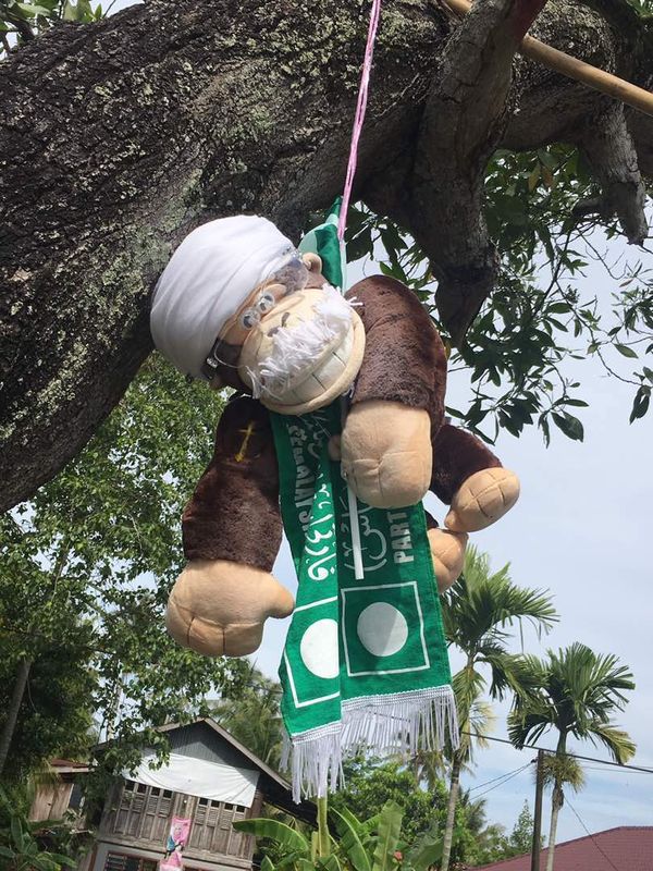 A toy monkey dangled in the air from a large tree on Jalan Tandop, Alor Setar, April 29, 2017.