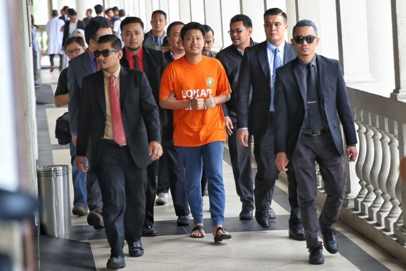 Ampang PKR Youth chief Adam Rosly arrives at the Kuala Lumpur Court Complex, escorted by anti-corruption officers, to face money laundering charges, April 21, 2017. u00e2u20acu2022 Picture by Saw Siow Feng
