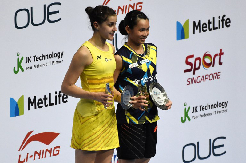 Winner Tai Tzu-Ying of Taiwan (right) poses on the podium with second-placed Carolina Marin of Spain after their womenu00e2u20acu2122s singles final of the Singapore Open badminton tournament in Singapore on April 16, 2017. u00e2u20acu201d AFP pic