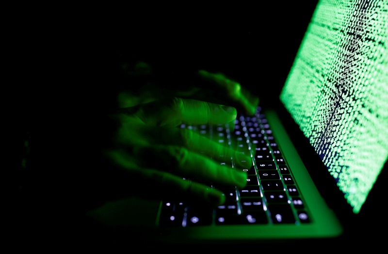 A man types on a computer keyboard in front of the displayed cyber code in this illustration picture taken on March 1, 2017. u00e2u20acu201d Reuters pic 