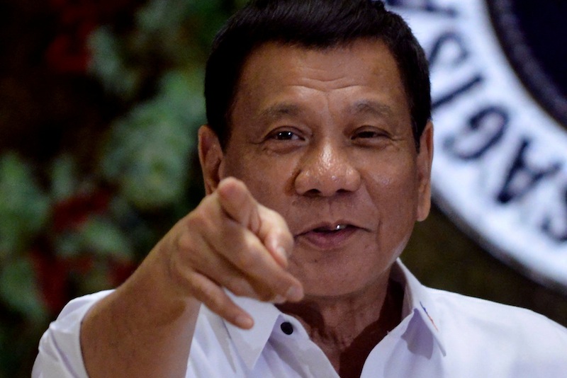 Philippine President Rodrigo Duterte points to photographers during an awarding ceremony for outstanding government workers, at the Malacanang Palace in Manila, Philippines December 19, 2016. u00e2u20acu201d Reuters pic