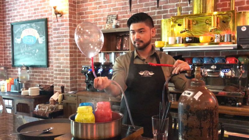 Central Perk director Derrick Ong prepares Chandler's Edible Helium Ballon, which comes in flavours such as strawberry, is inflated with a helium tank and served with a plated dessert. u00e2u20acu2022 Picture by Sonia Yeo/TODAY