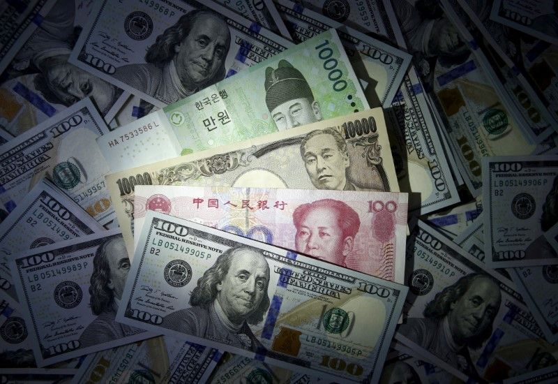 South Korean won, Chinese yuan and Japanese yen notes are seen on US 100 dollar notes in this file photo illustration shot April 15, 2017. u00e2u20acu2022 Reuters pic