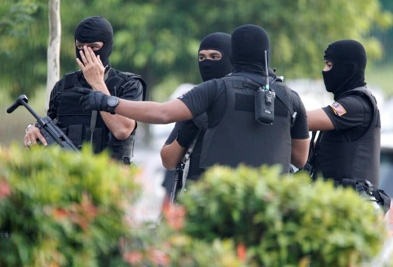 Armed policemen stand guard before the arrival of suspects charged with the murder of Kim Jong Nam, at a Sepang court, April 13, 2017. u00e2u20acu2022 Reuters pic