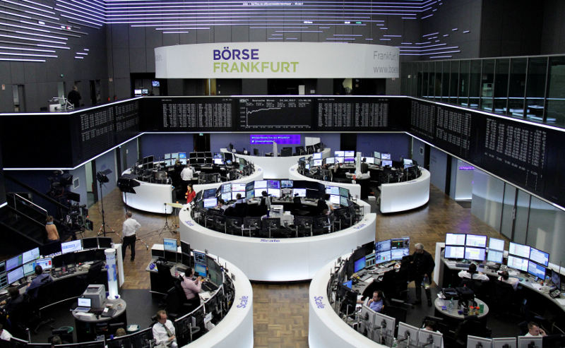 Traders work at their desks in front of the German share price index, DAX board, at the stock exchange in Frankfurt April 24, 2017. u00e2u20acu201d Reuters pic
