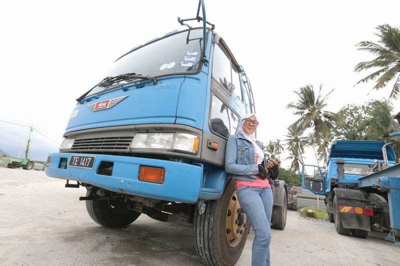 Rokiah in front of her 10-wheeler truck at the Permatang Pauh truck depot in Butterworth. u00e2u20acu201d Pictures by Sayuti Zainuddin