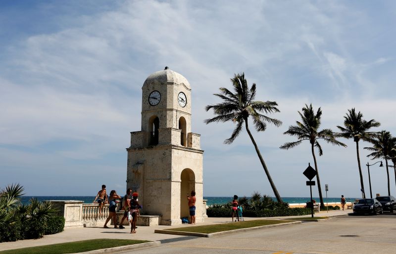 Beachgoers walk along Ocean Ave. near the Mar-a-Lago estate in Palm Beach April 5, 2017.. u00e2u20acu201d Reuters pic
