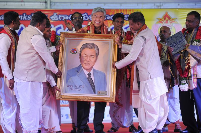 Deputy Prime Minister Datuk Seri Dr Ahmad Zahid Hamidi receiving a gift after launching the Ugadi Carnival 2017 at Dataran Merdeka in Kuala Lumpur, April 23, 2017. u00e2u20acu201d Bernama pic
