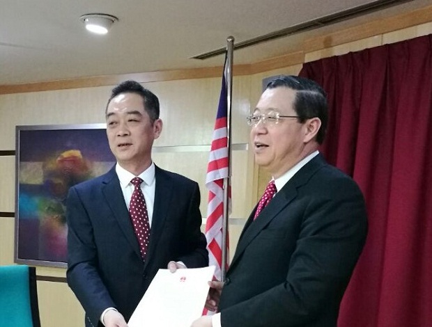 China Consul-general to Penang Wu Jun hands over a letter on the warshipsu00e2u20acu2122 visit to  Penang Chief Minister Lim Guan Eng. u00e2u20acu201d Picture by Opalyn Moknn