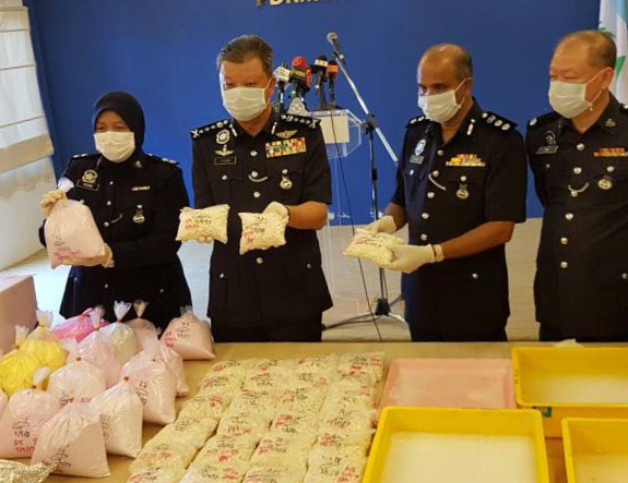 Penang Police Chief Datuk Chuah Ghee Lye (second from left) showing the drugs that were seized in the raid. u00e2u20acu201d Picture by Opalyn Mok