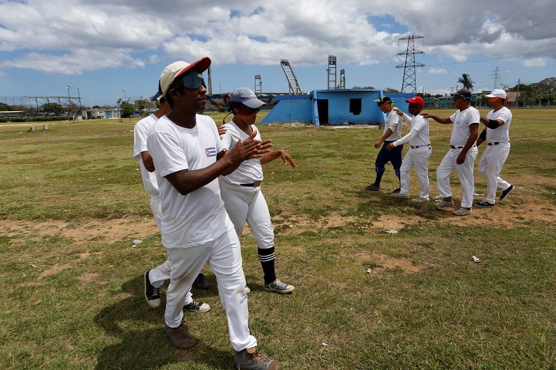The visually impaired walk at the Changa Medero stadium during a baseball lesson, in Havana.